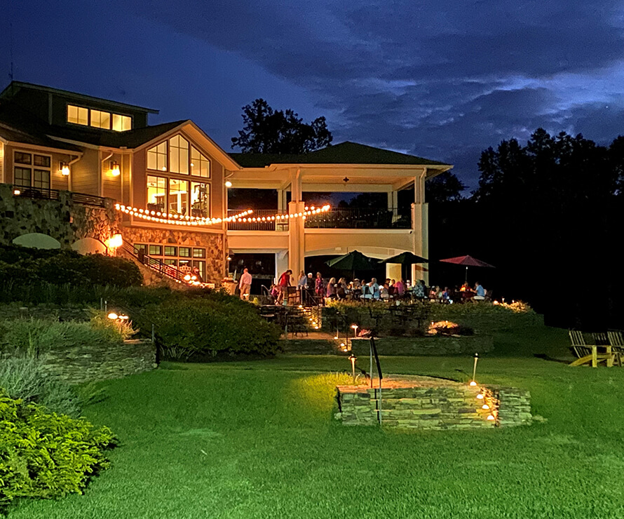 members enjoying the clubhouse deck at night