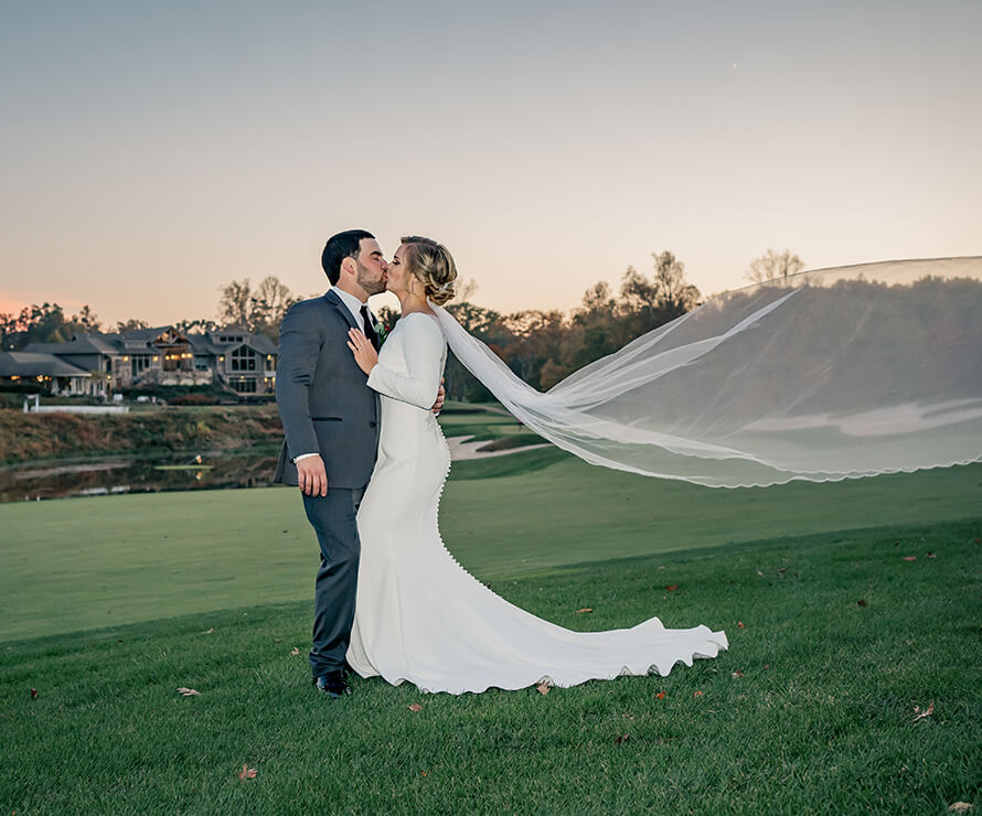 bride and groom by golf course